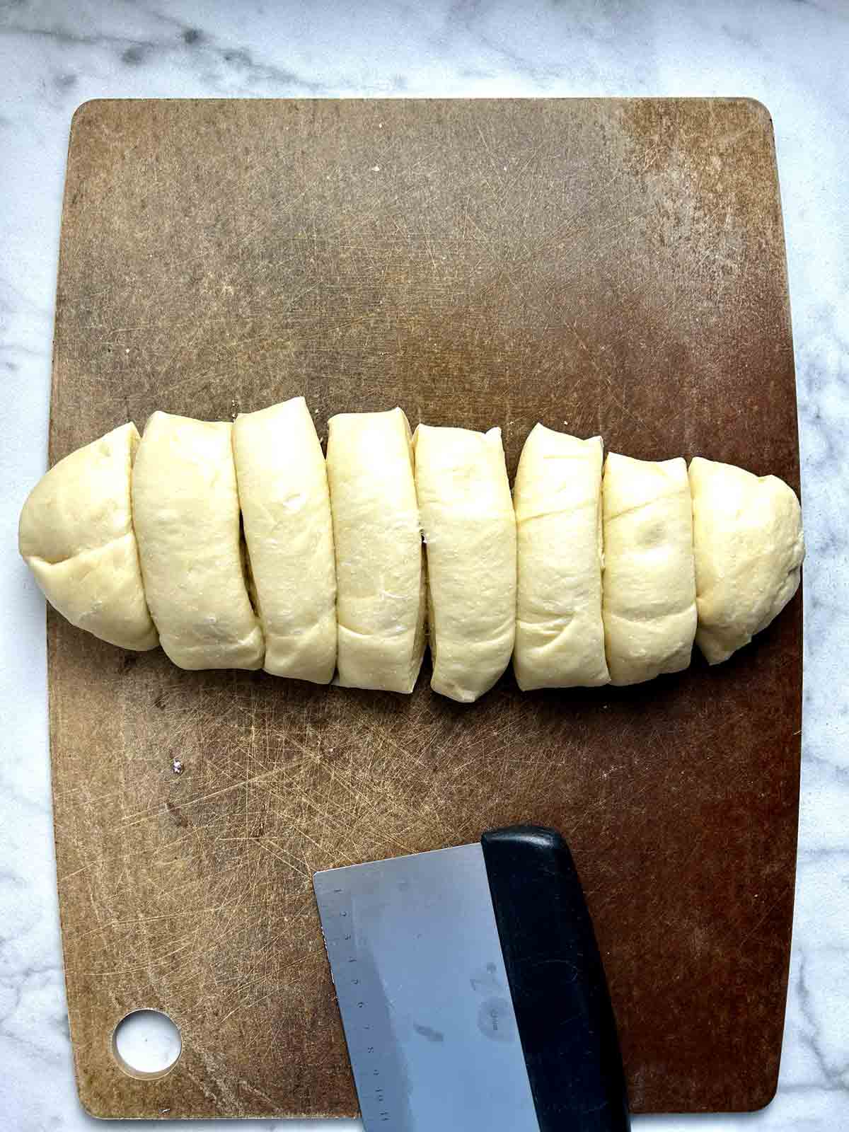 log of dough cut into 8 sections.