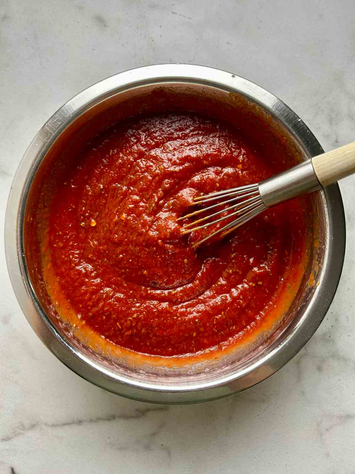ingredients whisked together in metal bowl.