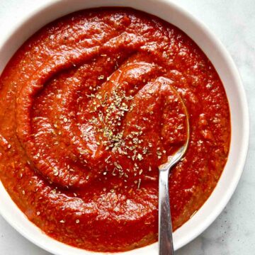 pizza sauce in bowl with spoon.