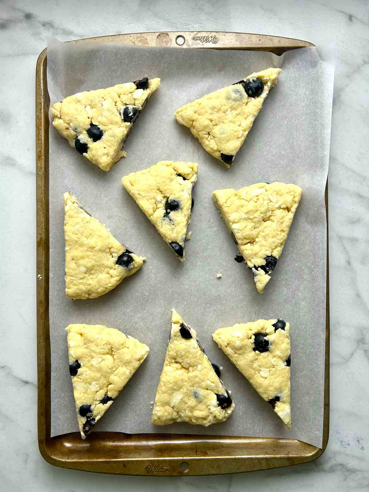 scones placed on baking sheet with parchment paper.