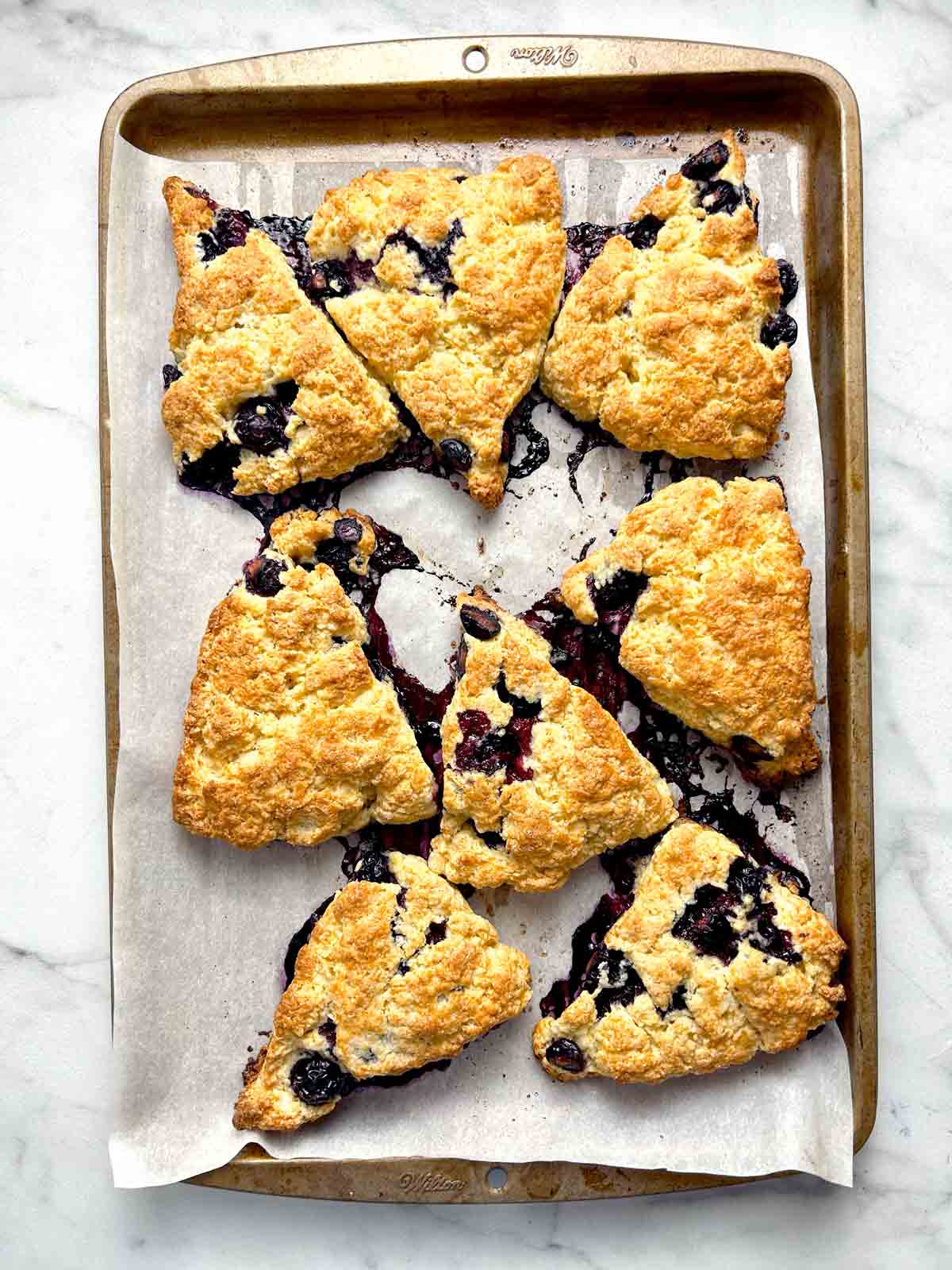 scones after being baked; golden brown and blueberries melting off.