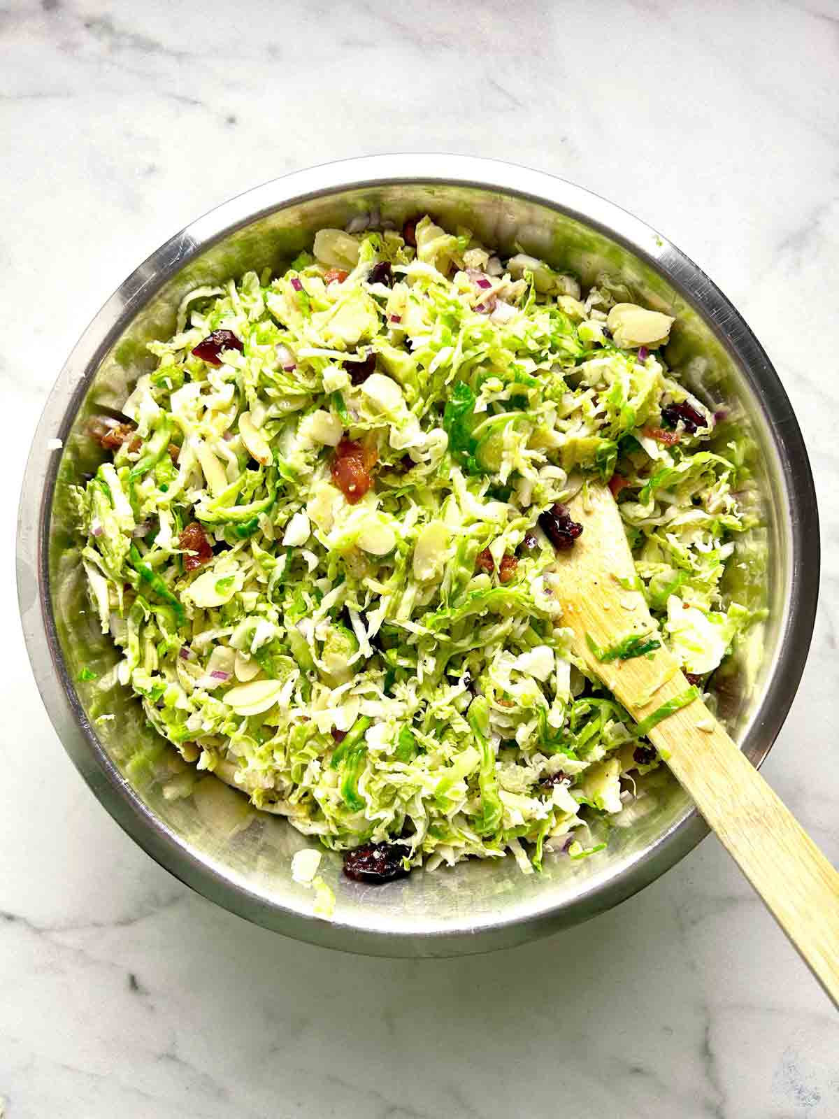 all salad ingredients tossed together in bowl.