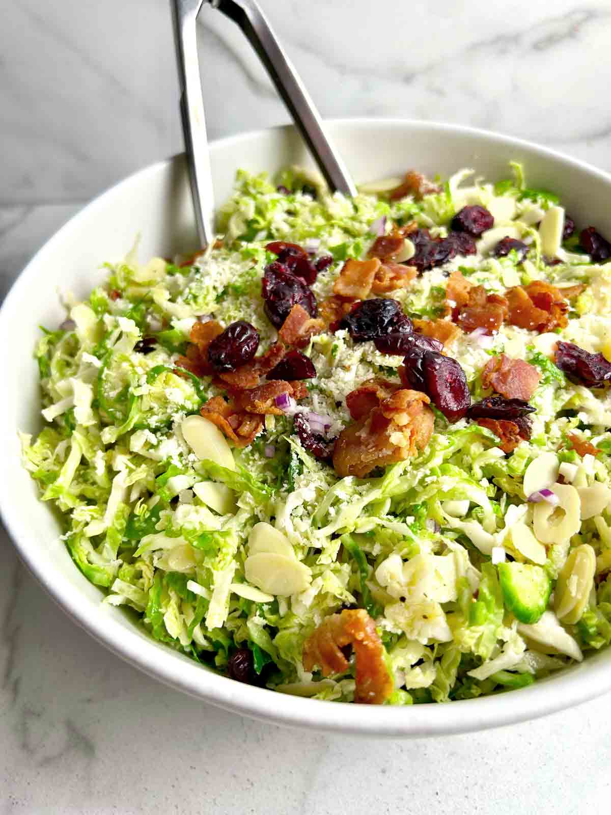 close up of shaved Brussels sprouts salad in bowl.