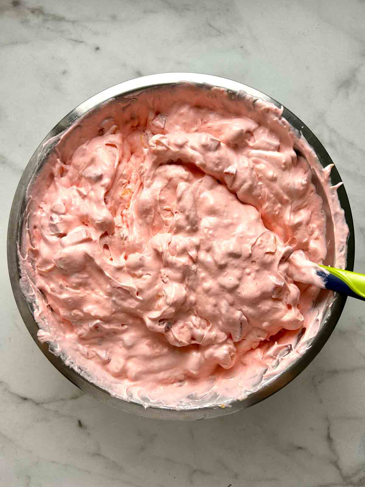 berries, marshmallows, and pineapple mixed into cream mixture.