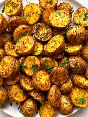 close up of crispy potatoes on plate.