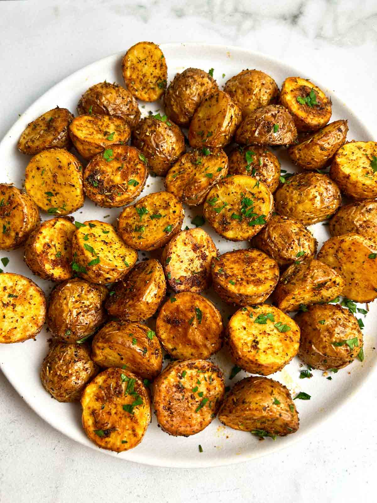 close up of crispy potatoes on plate.