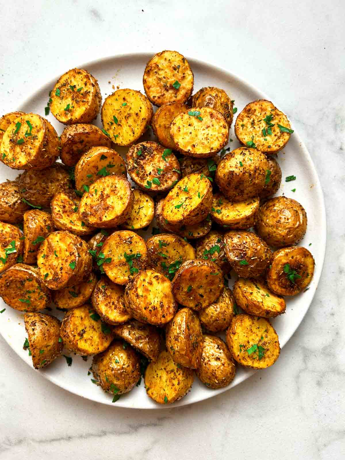 close up of crispy potatoes on plate.