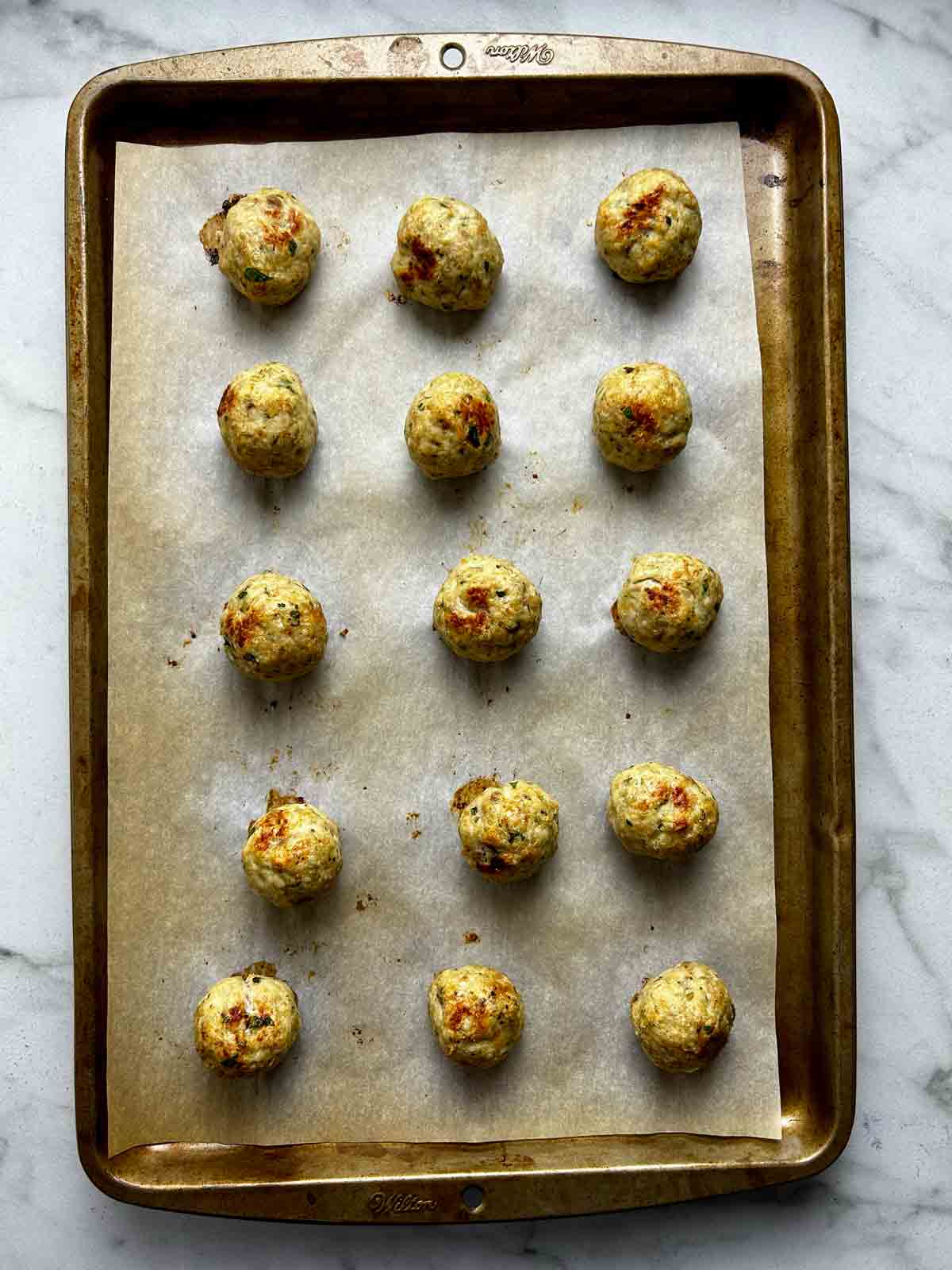chicken meatballs on pan after baking.
