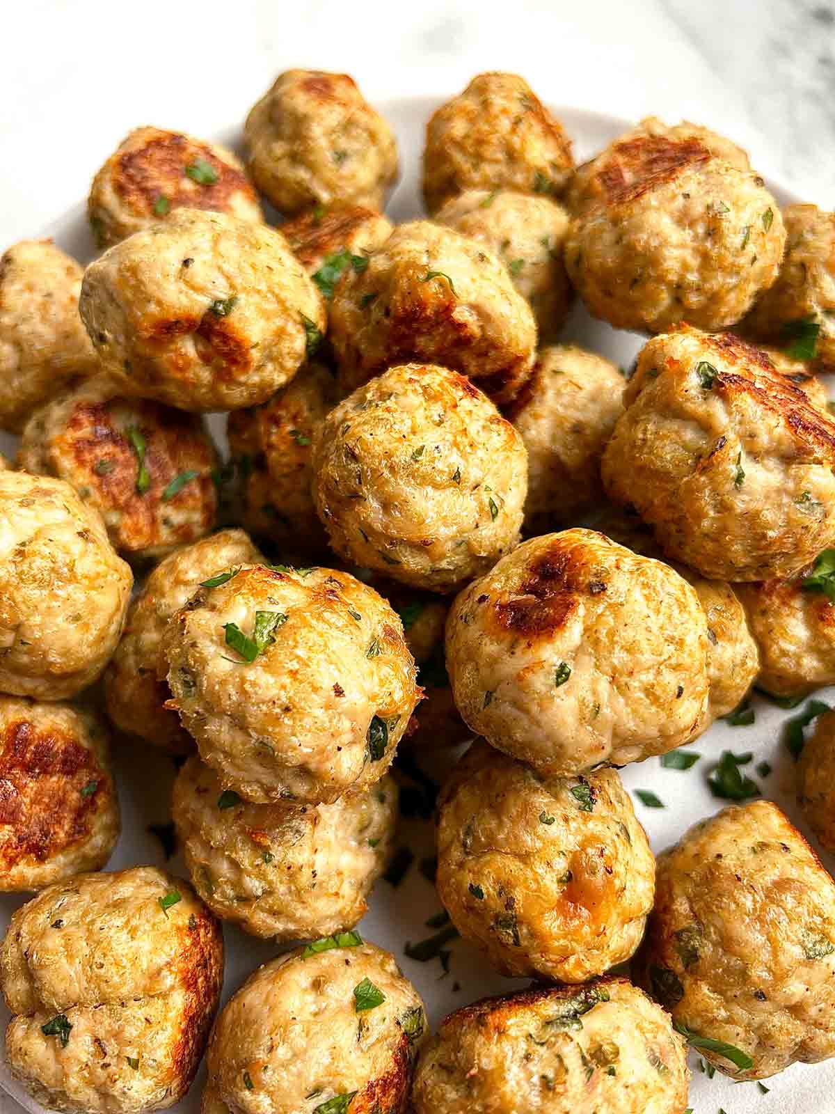 close up of chicken meatballs on plate.