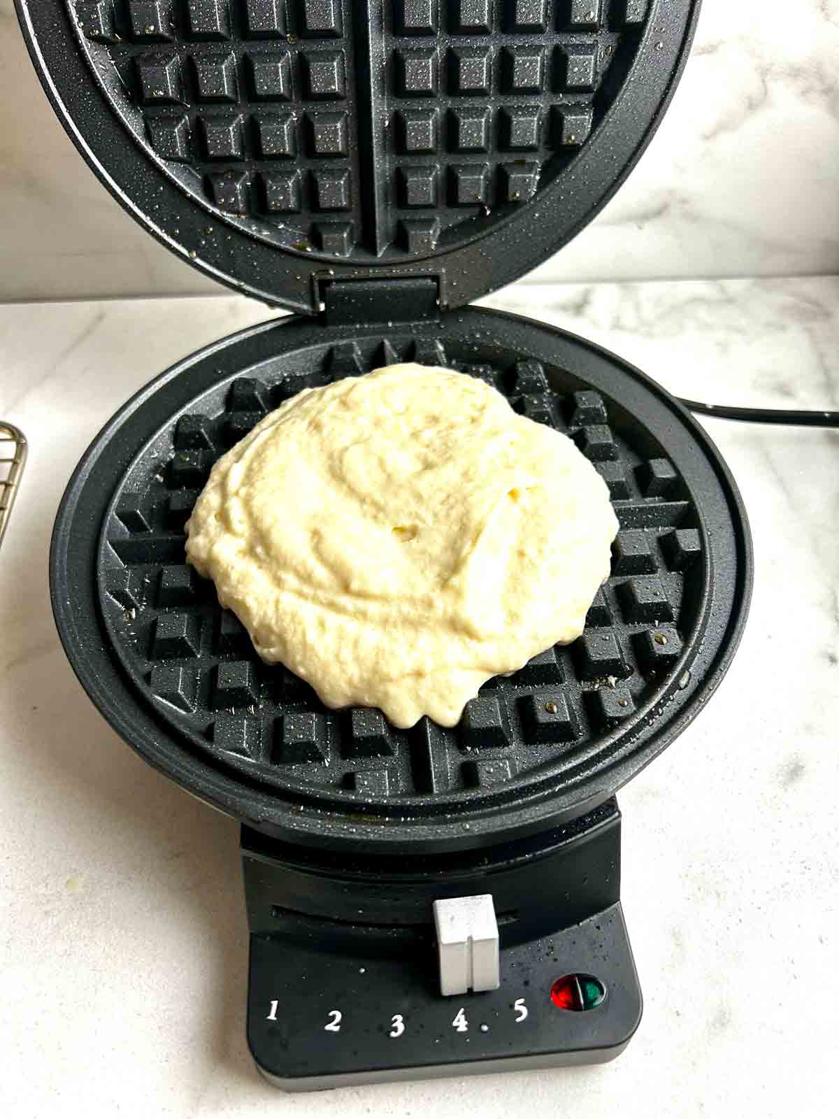 batter scooped into center of waffle iron.