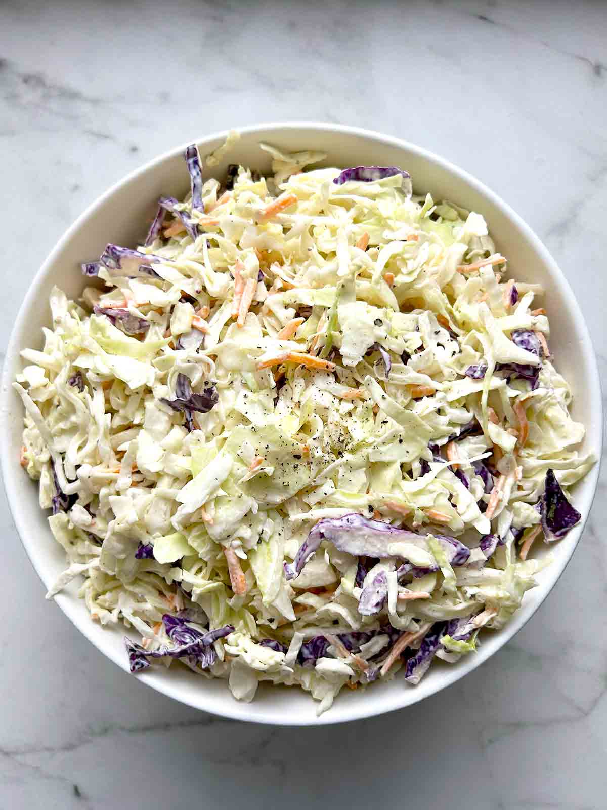 coleslaw mixed in large white bowl.
