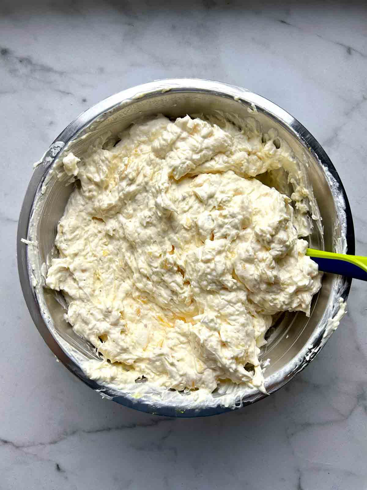 Cool whip folded into pineapple jello mixture.