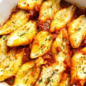 close up of stuffed shells in baking dish.