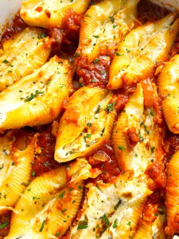 close up of stuffed shells in baking dish.