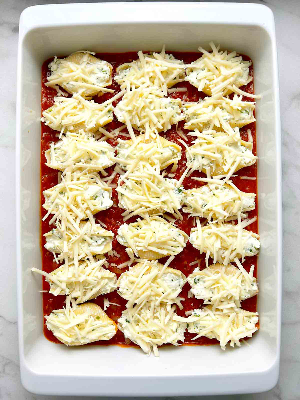 mozzarella cheese sprinkled onto shells.