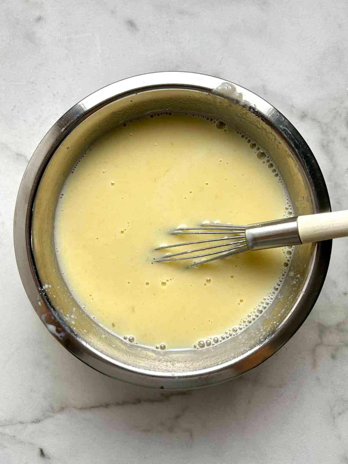 wet ingredients whisked in bowl.