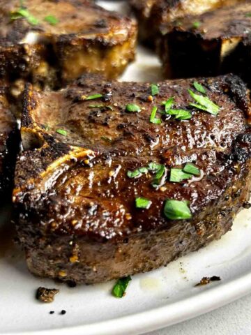close up of baked lamb loin chop on plate.