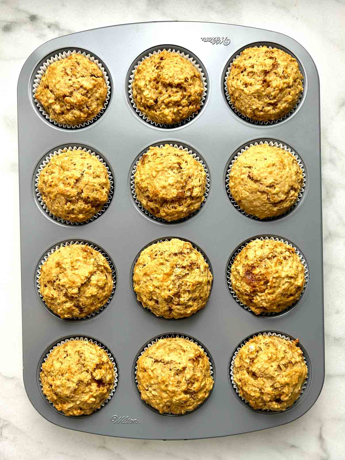 muffins after baking; domed top and golden brown.