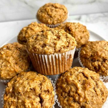 oatmeal applesauce muffins stacked onto plate.