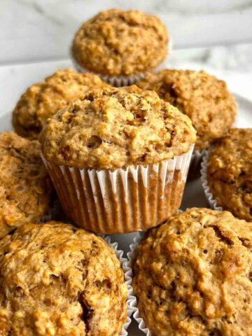 oatmeal applesauce muffins stacked onto plate.