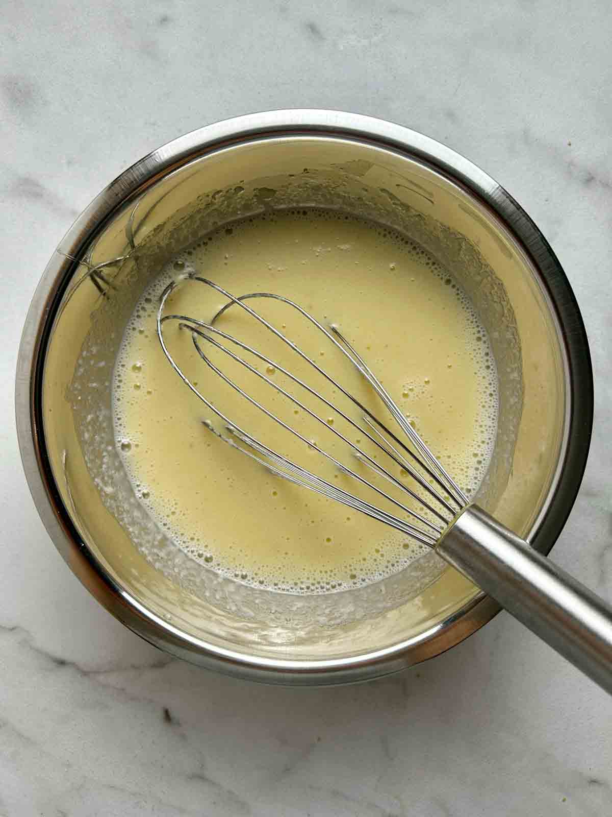 wet ingredients whisked together in bowl.