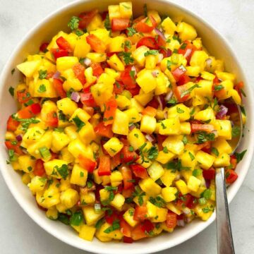 bowl of pineapple salsa with spoon.