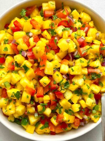 bowl of pineapple salsa with spoon.