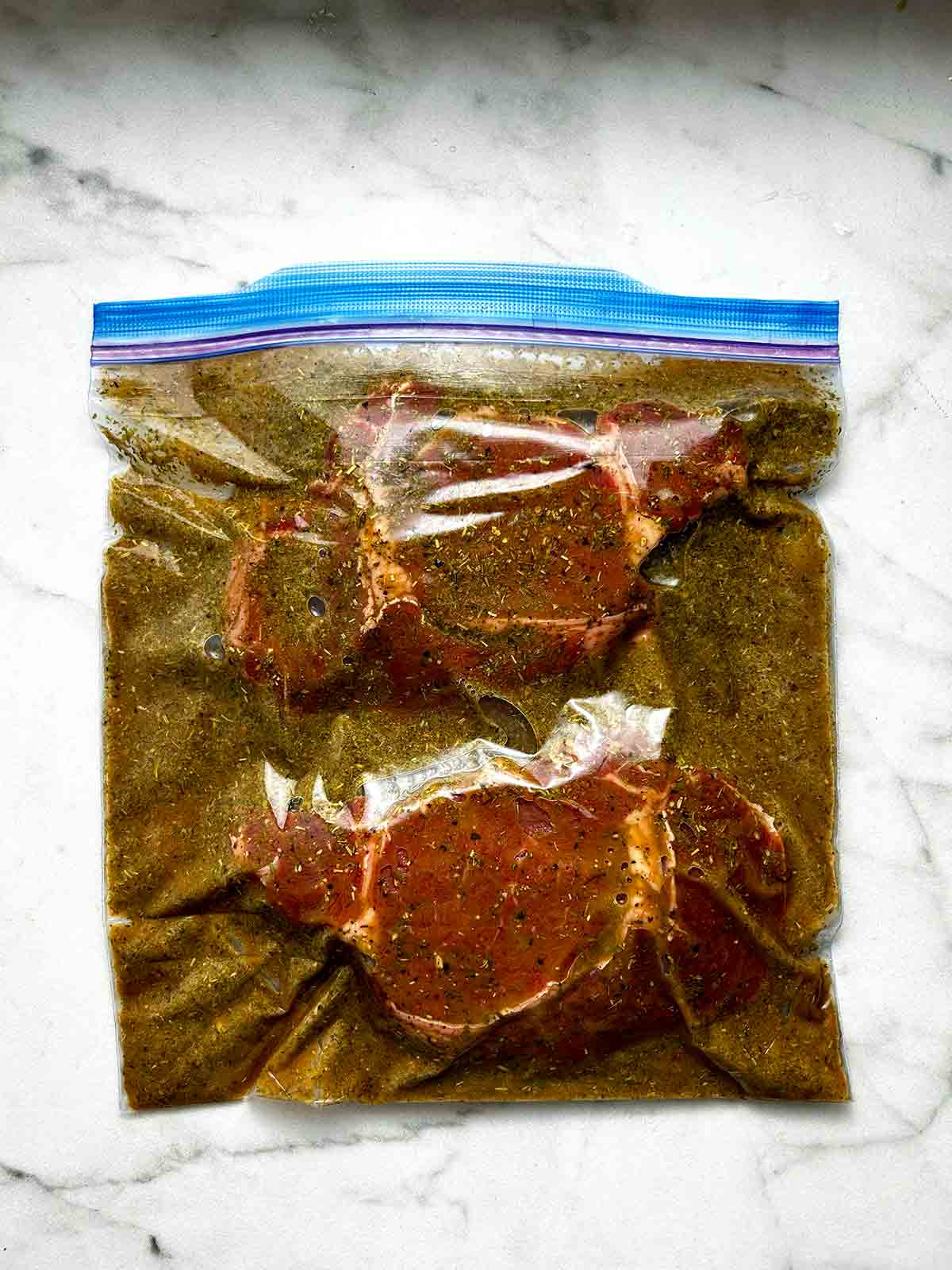 raw steak in plastic bag with marinade.