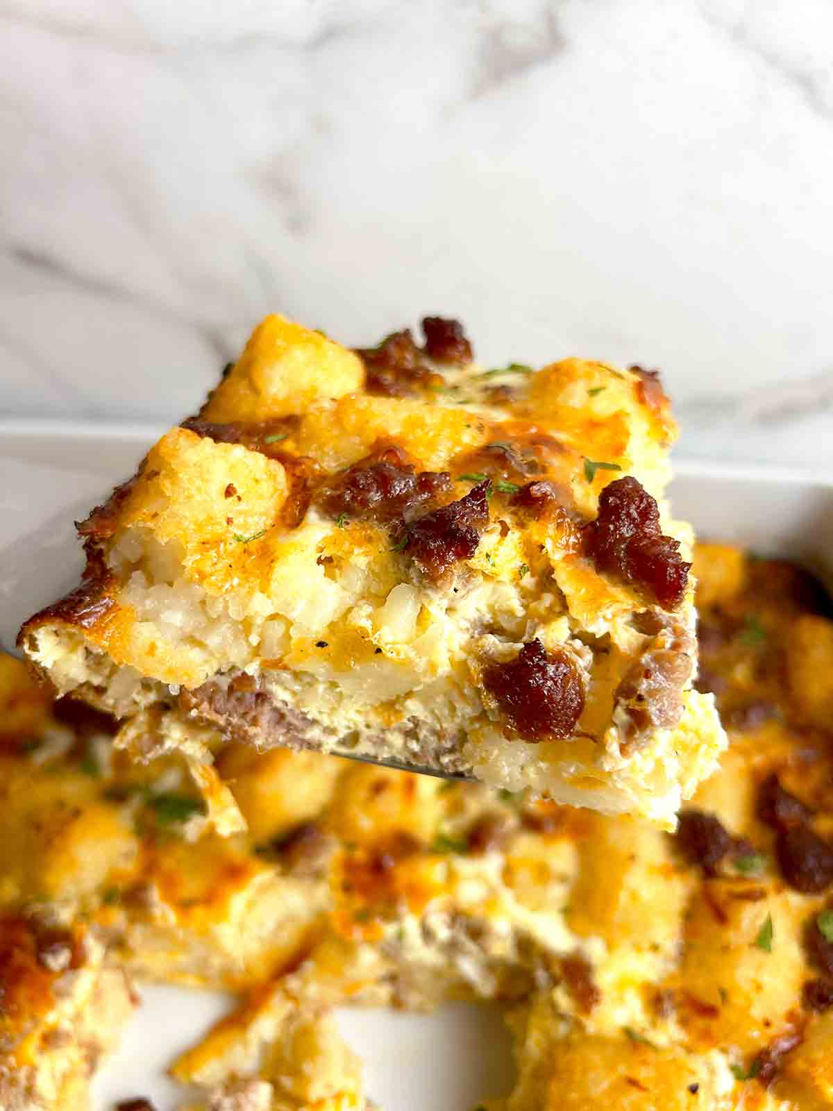 spatula lifting slice of casserole.