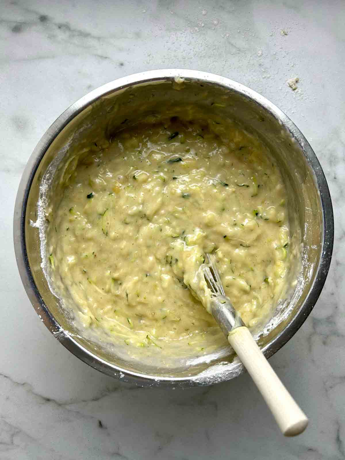 muffin batter whisked in bowl.