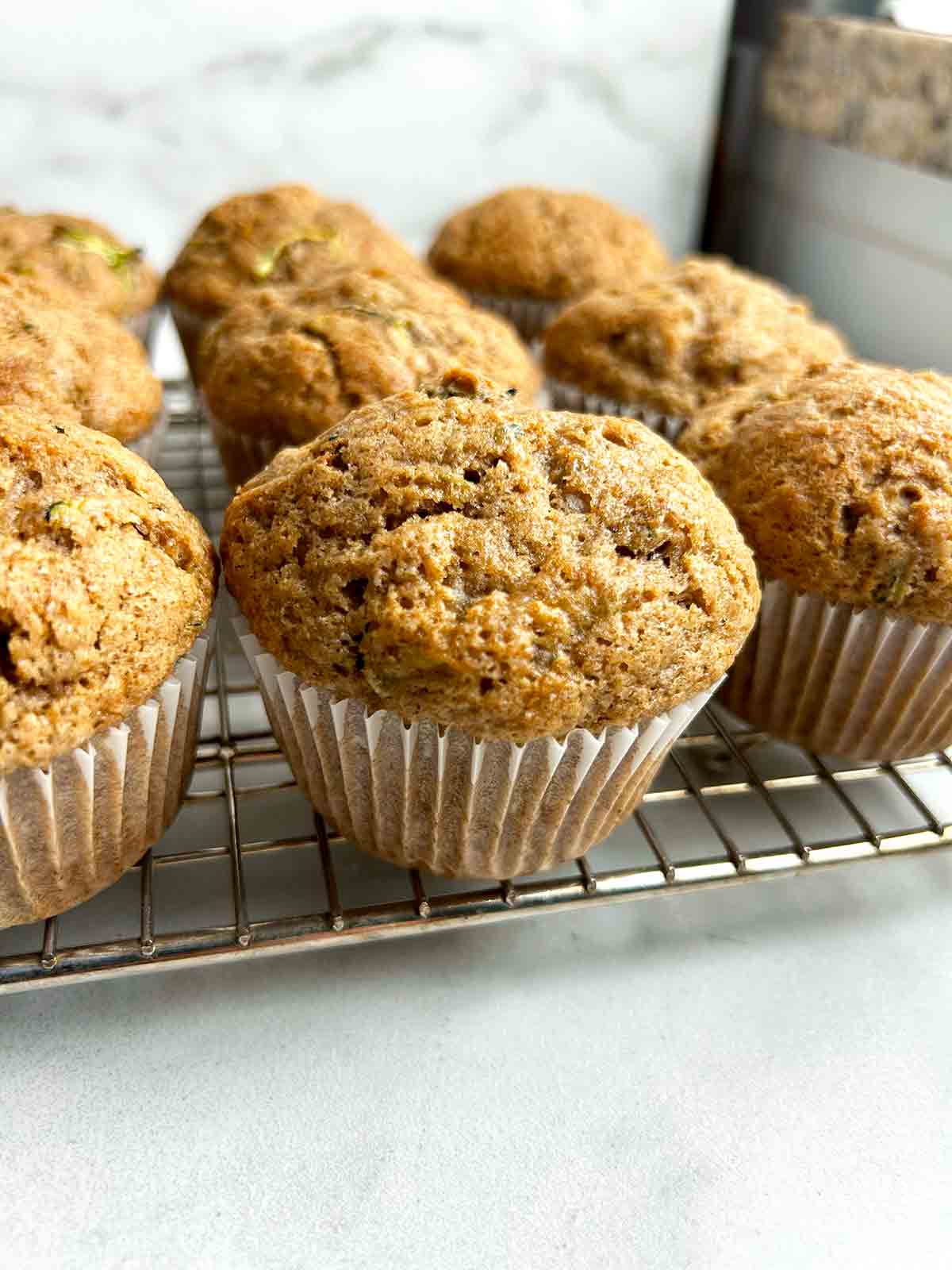 zucchini banana muffins drying on wire rack.