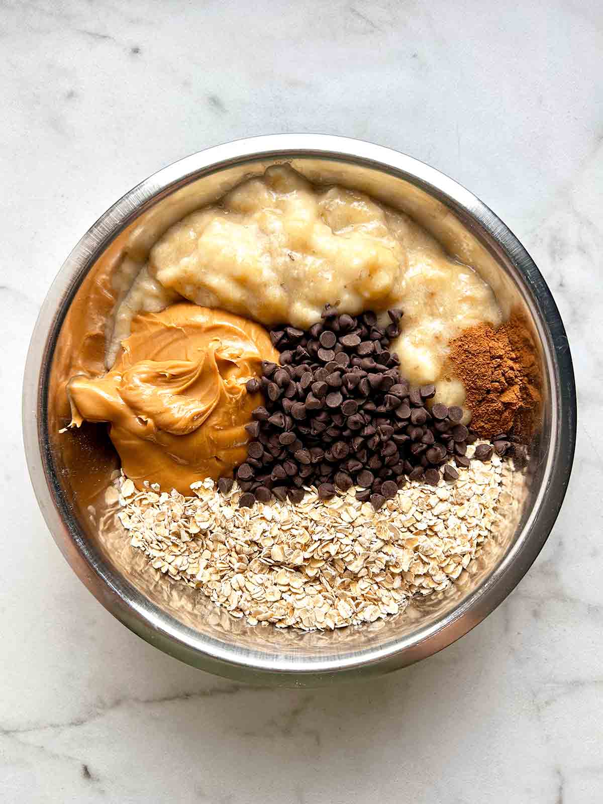 ingredients for breakfast cookies arranged in a metal bowl.