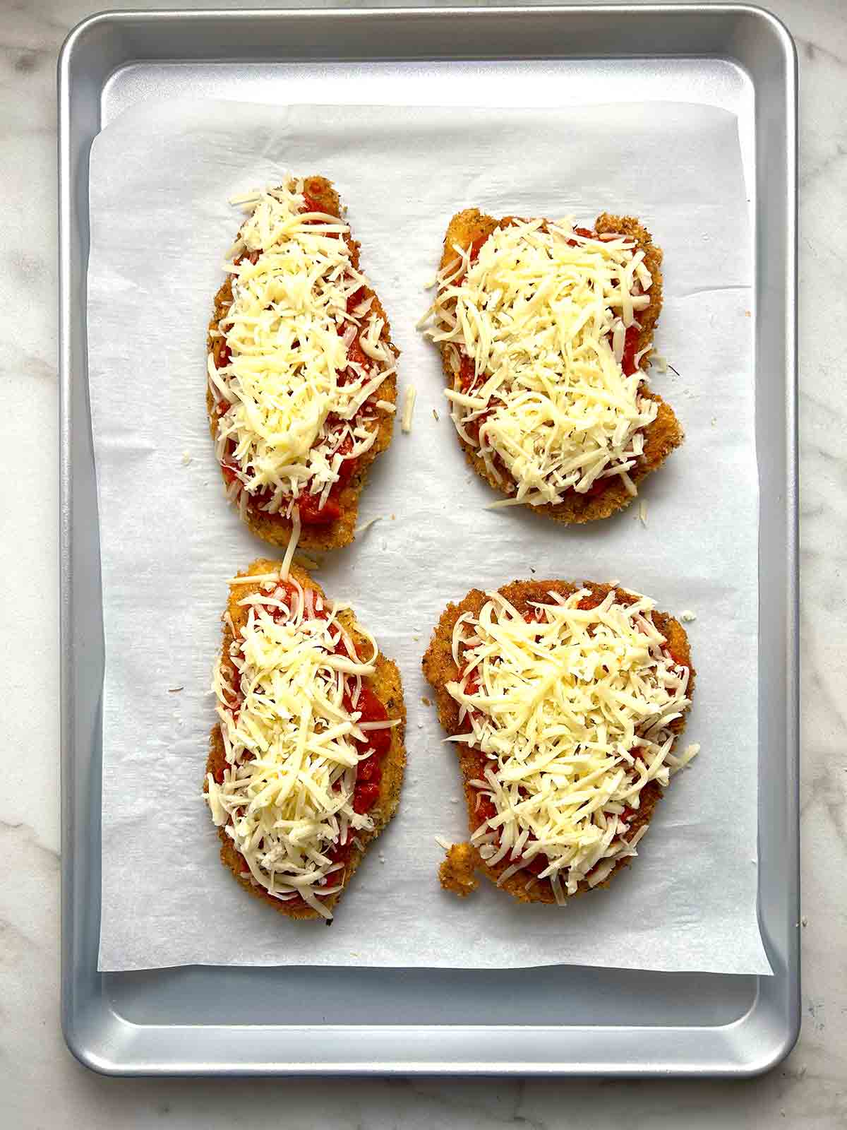 marinara and cheese added on top of breaded chicken.