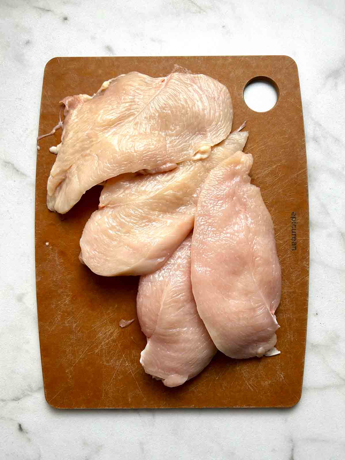 two chicken breasts cut into 4 smaller cutlets.