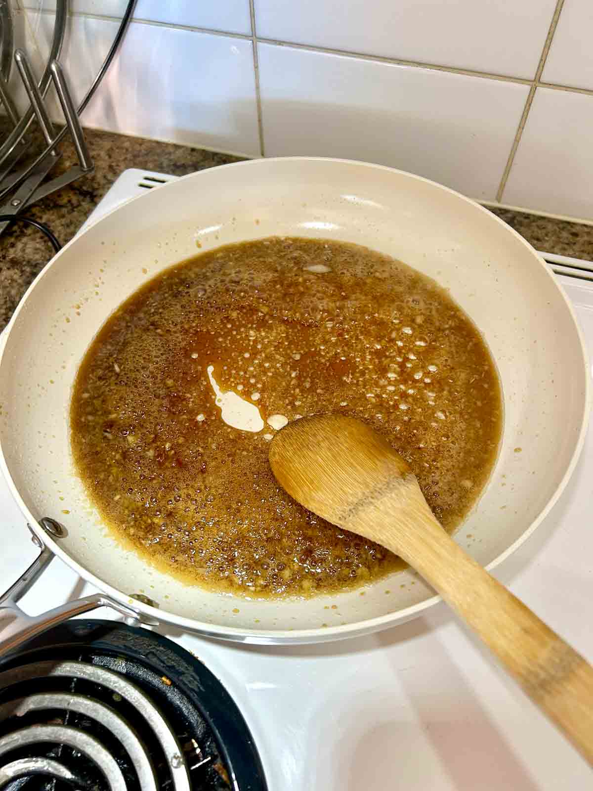 honey garlic sauce simmering in large skillet.