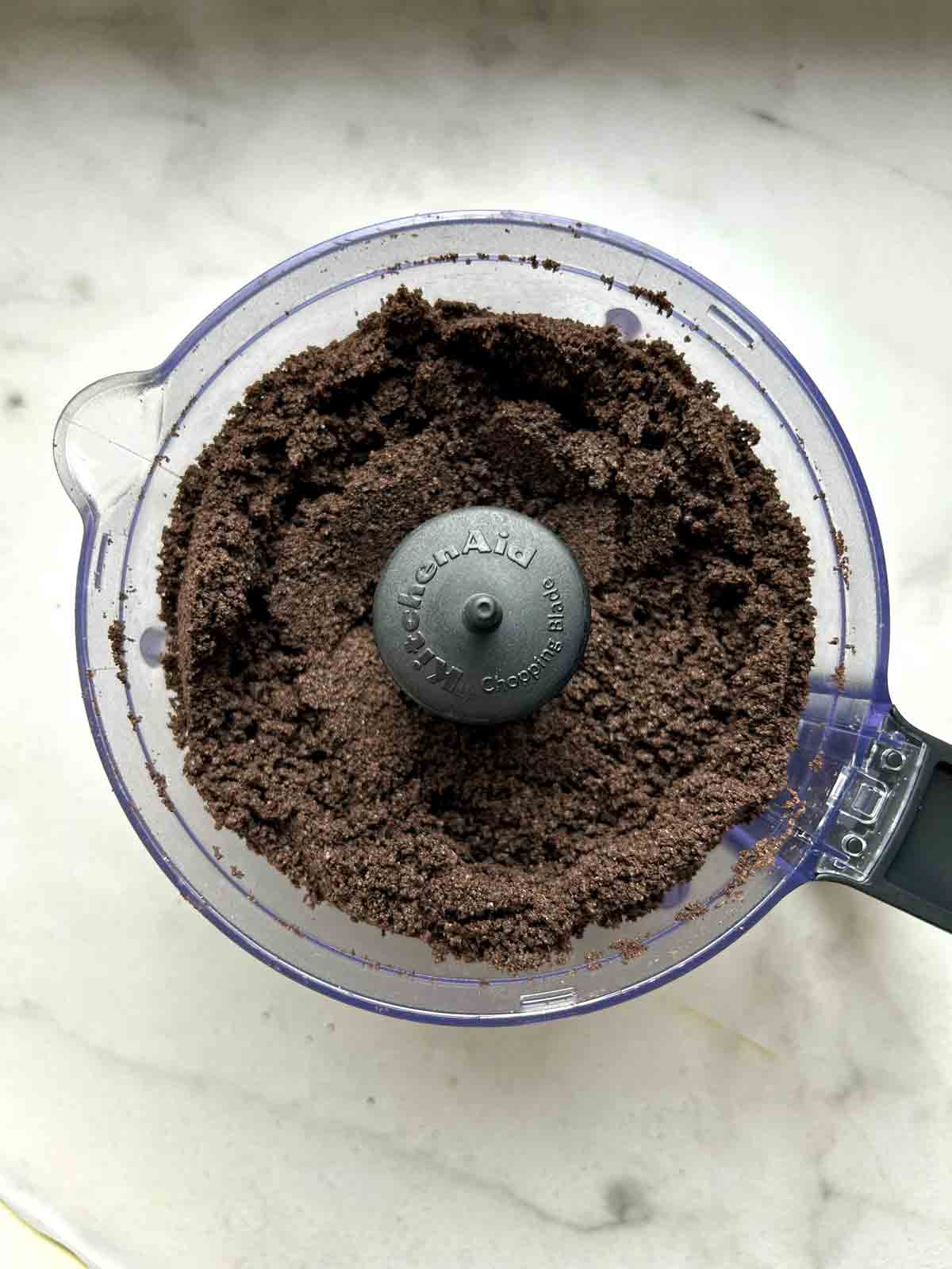 Oreo cookies blended into fine crumbs in food processor.