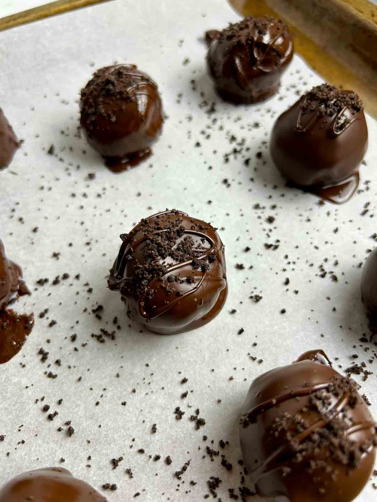 close up of Oreo balls with extra crumbs sprinkled on top.